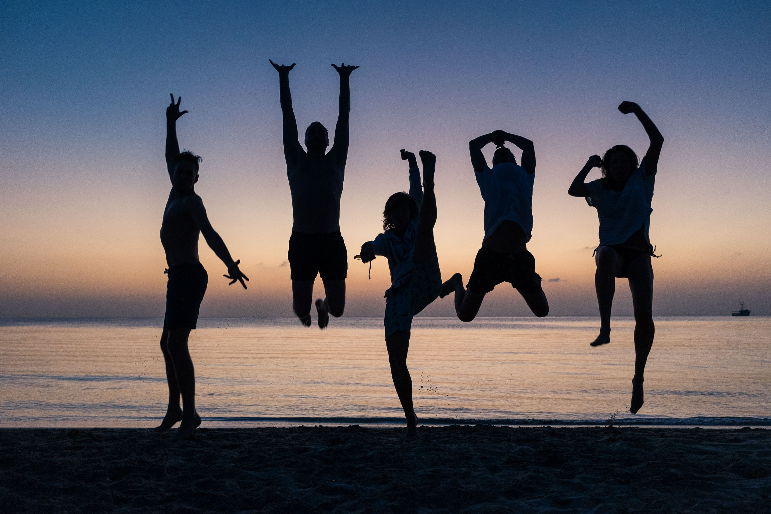 Friends jumping at sunset